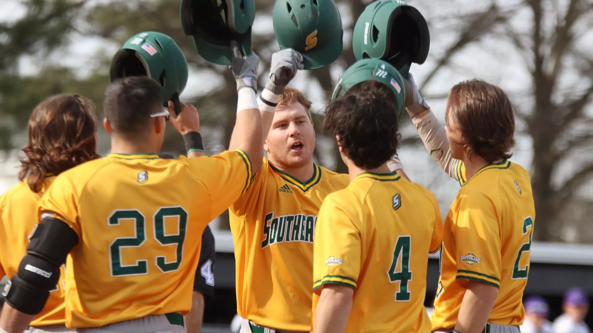Preston Faulkner celebrates a grand slam with teammates
