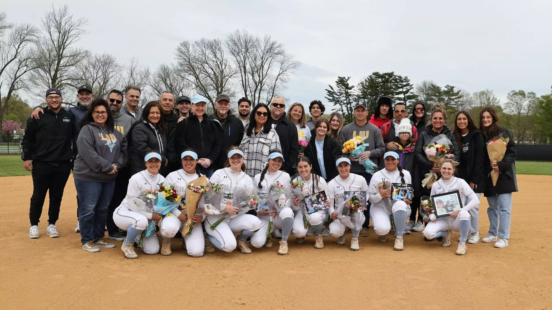 Softball senior day group photo in infield with families