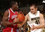 Linas Kleiza and Arkansas' Rashard Sullivan fight over a rebound in the first half.