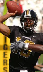 Missouri quarterback Brad Smith, left, tosses a pass as he is hit by Ball State's Lorenzo Wims, right, in the first half Saturday, Sept. 18, 2004, in Columbia, Mo.