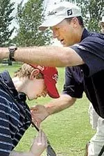 Stan Utley helps 13-year-old T.J. Cox of Marysville, Kan., with his swing Aug. 2, 2004, during the 14th annual Rainbow House Golf Classic at Country Club of Missouri. <I>(Photo by Michael McNamara / Columbia Daily Tribune)</I>