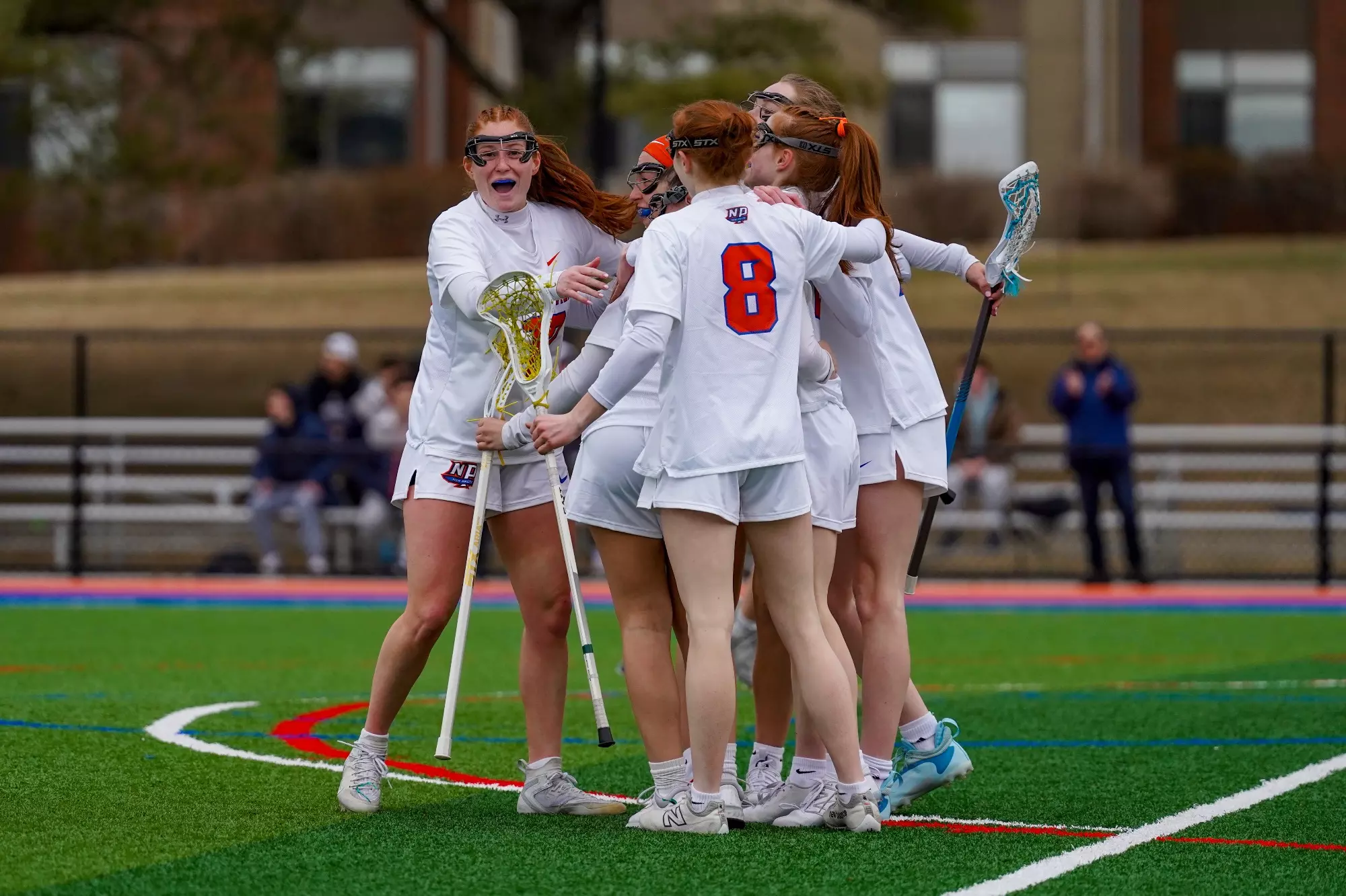 Lexi Atwater Goal Celebrate Team Huddle Hug