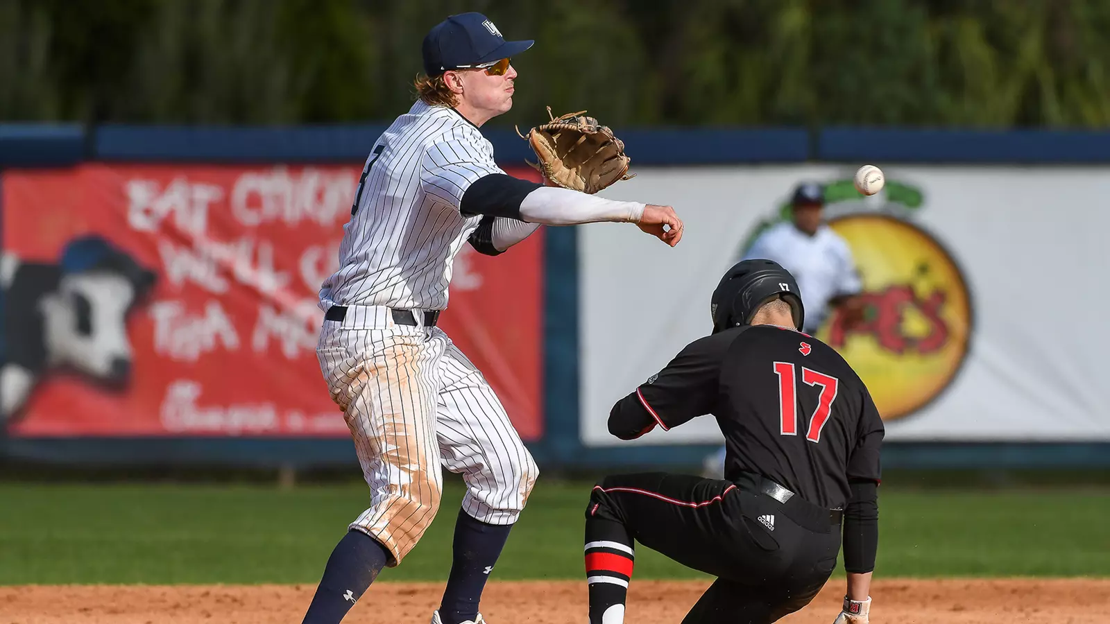 Tanner May throws the ball over to first
