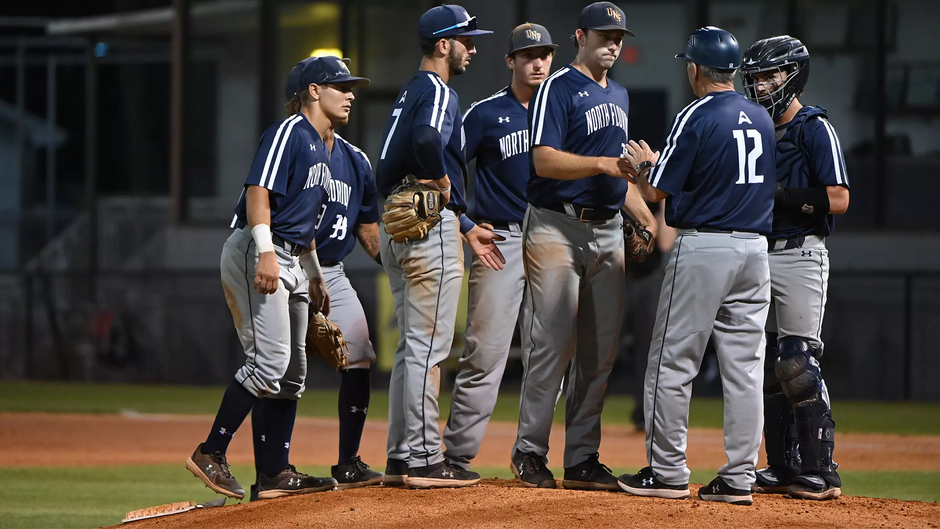 team meeting on the mound for UNF baseball