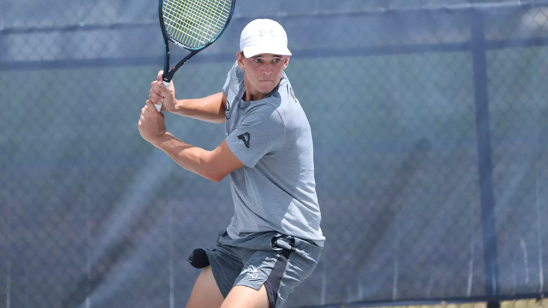 PJ Kotan returns ball in singles play