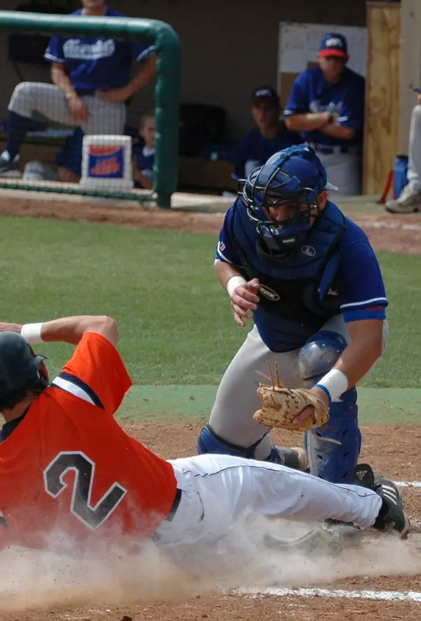 Catcher Adam Moore tags out a runner at home plate on Saturday