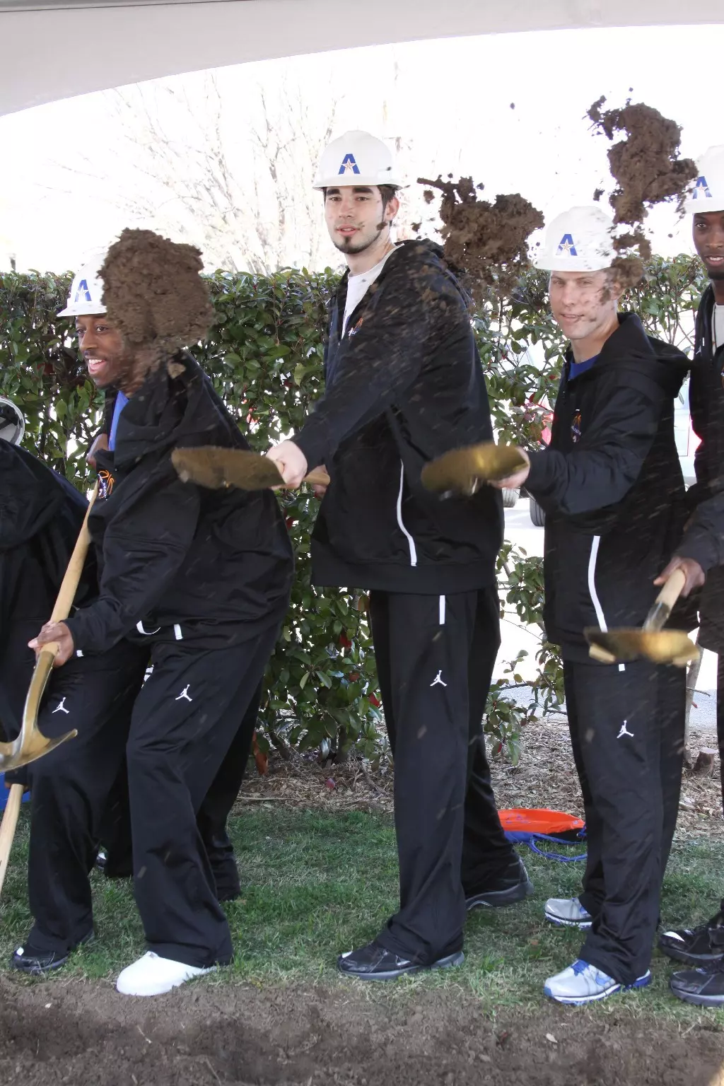 (From left to right) UTA men's basketball players LaMarcus Reed and Jordan Reves with coach Scott Cross at the ceremony