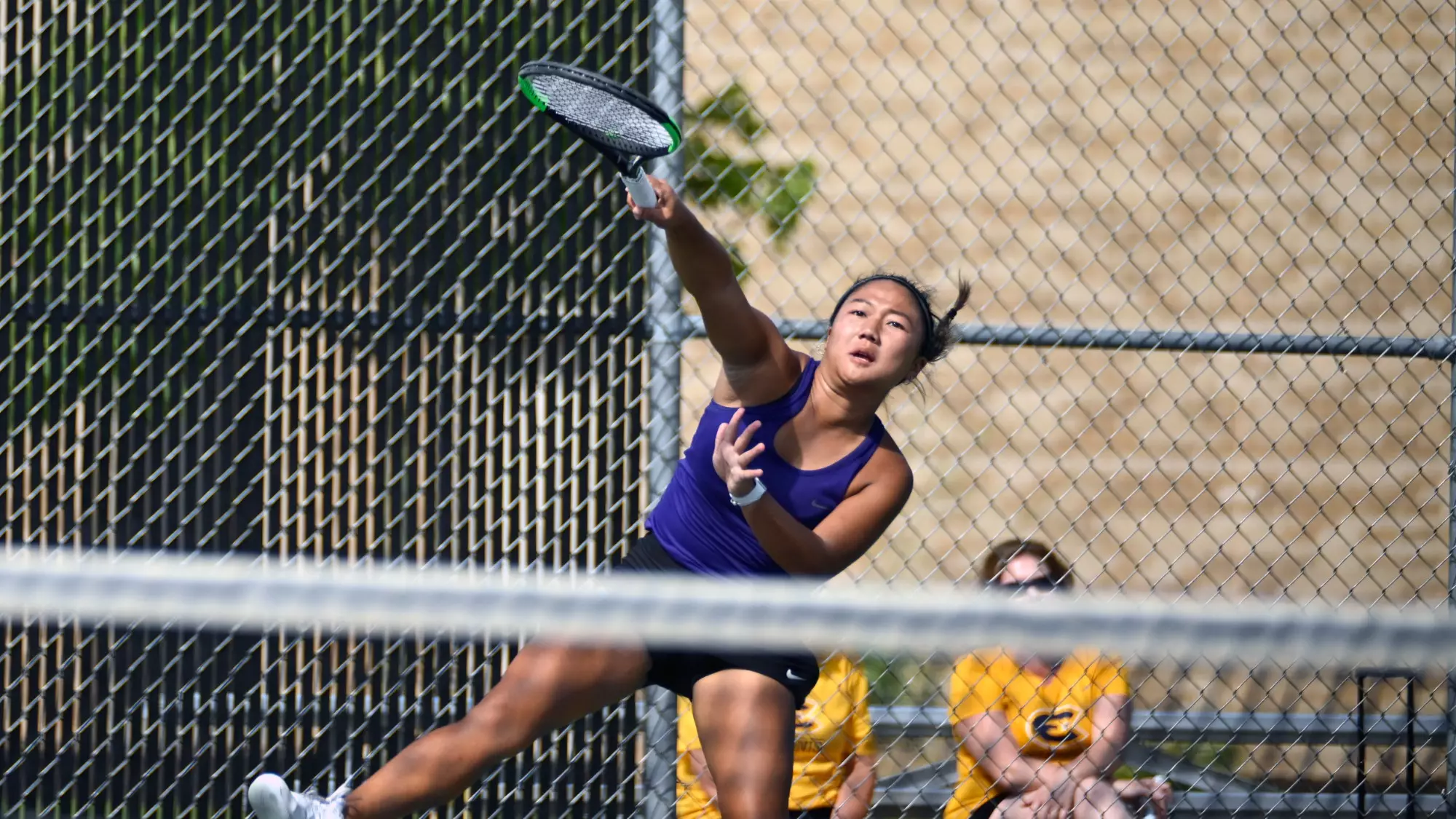 UW-W serves during doubles play