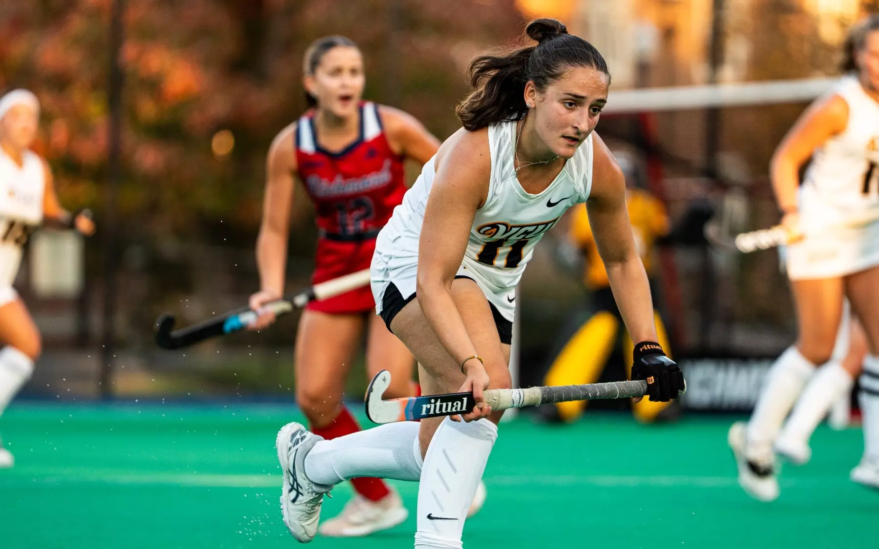 Angelina Gandos of VCU wearing a white #11 jersey readies to play defense in a game against Richmond