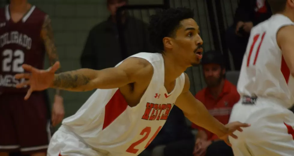 Western men's basketball player JJ Roberts plays defense against CMU