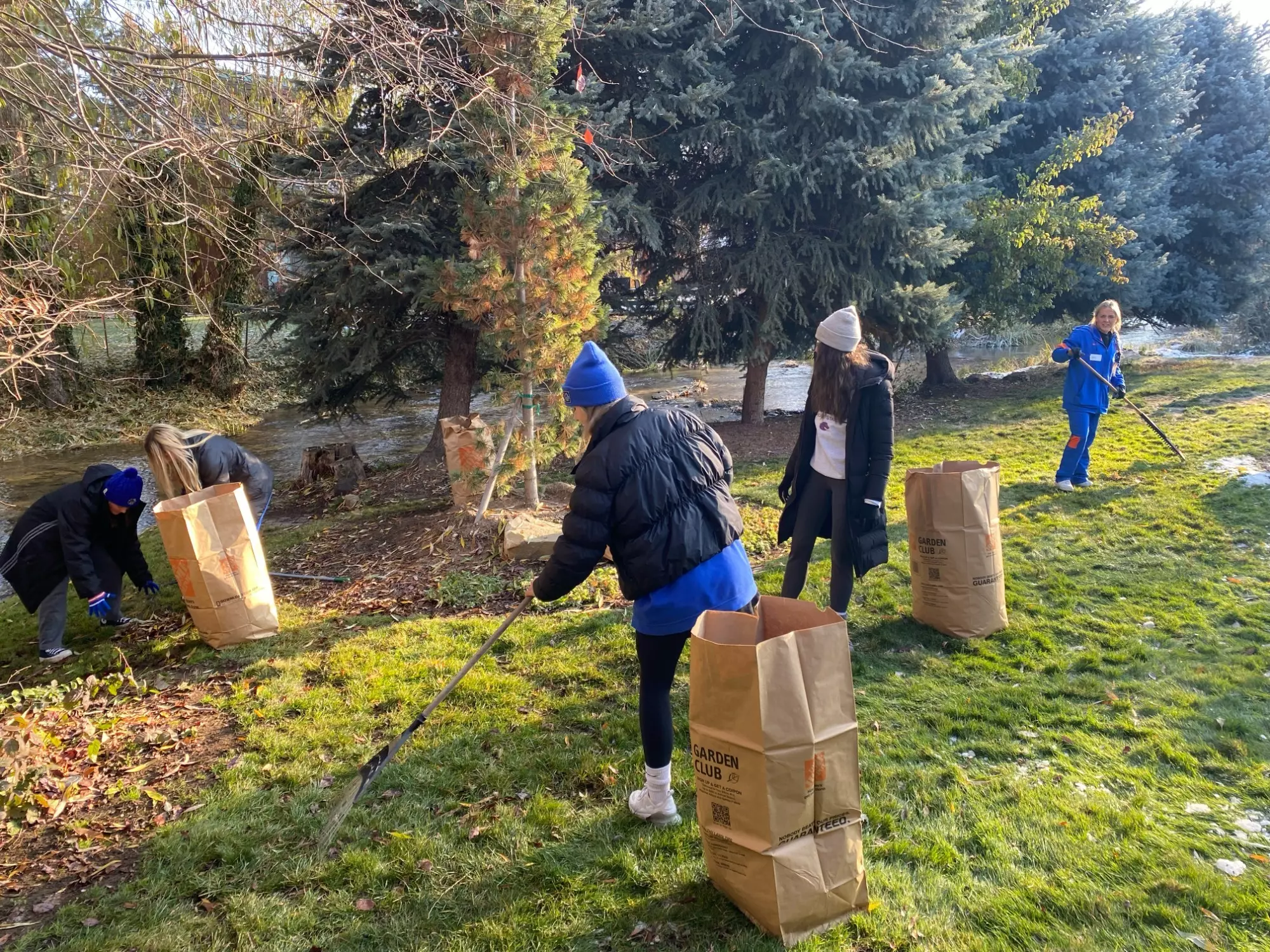 Boise State staff and student-athletes participate in Rake Up Boise.
