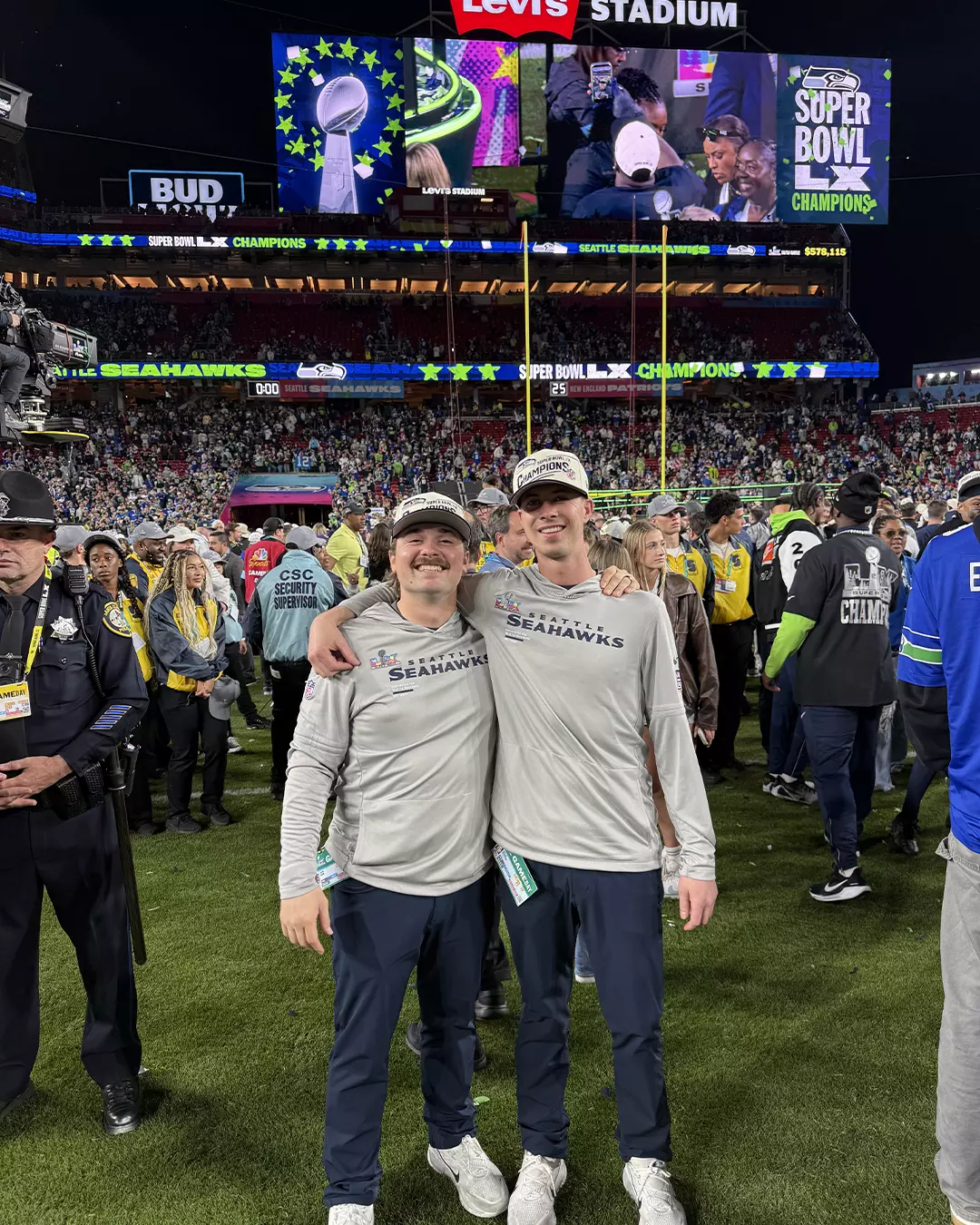 Easton Hudson and Doug DeKerchove on the field after winning the Superbowl