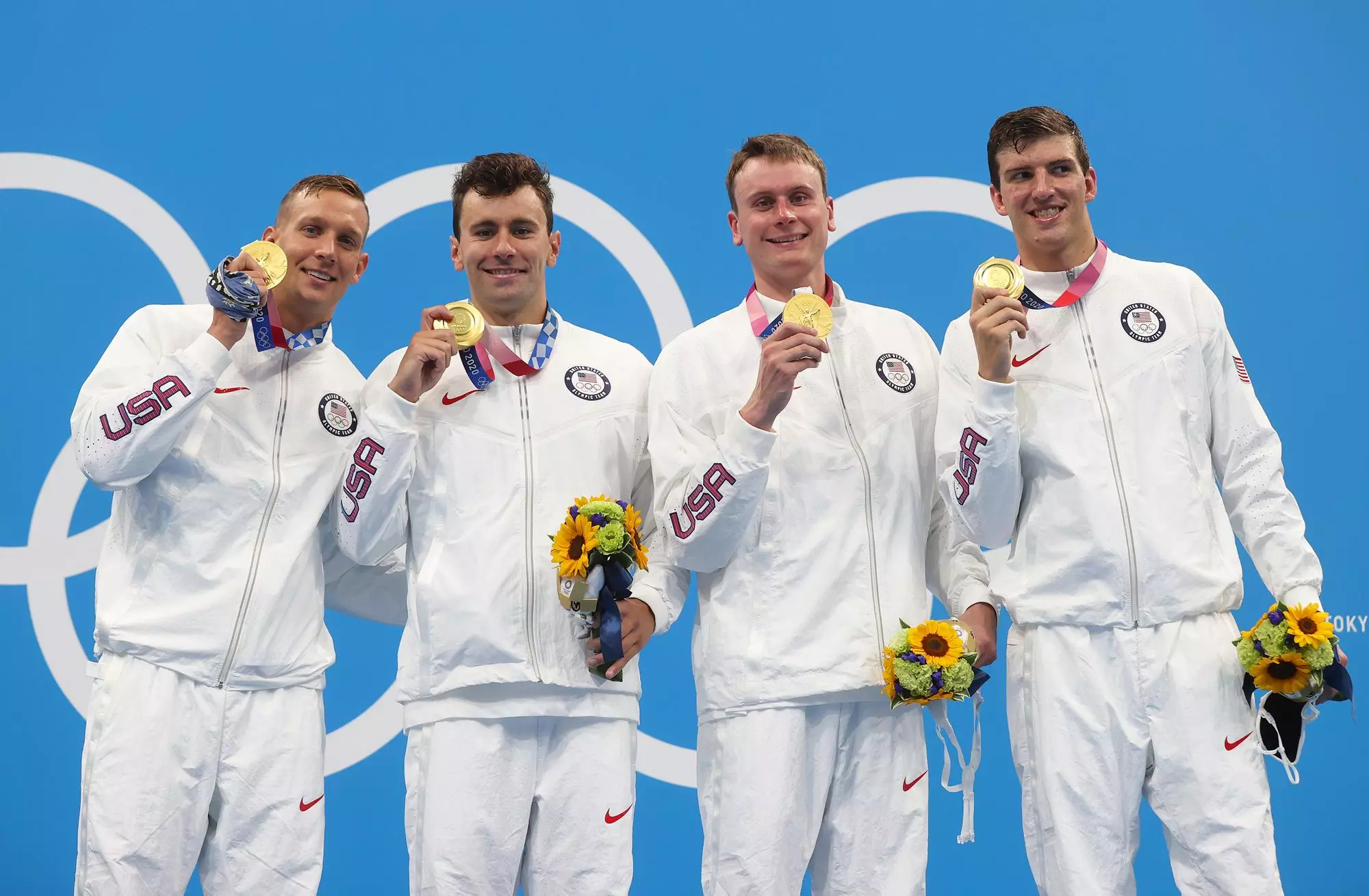 TOKYO, JAPAN - JULY 26: Caeleb Dressel, Blake Pieroni, Bowen Becker and Zach Apple of Team United States pose with their gold medals for the Men's 4 x 100m Freestyle Relay Final on day three of the Tokyo 2020 Olympic Games at Tokyo Aquatics Centre on July 26, 2021 in Tokyo, Japan. (Photo by Clive Rose/Getty Images)