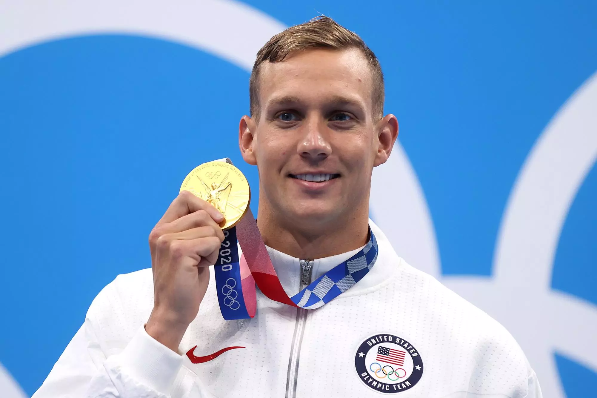 TOKYO, JAPAN - JULY 31: Gold medalist Caeleb Dressel of Team United States poses with the gold medal for the Men's 100m Butterfly Final at Tokyo Aquatics Centre on July 31, 2021 in Tokyo, Japan. (Photo by Clive Rose/Getty Images)
