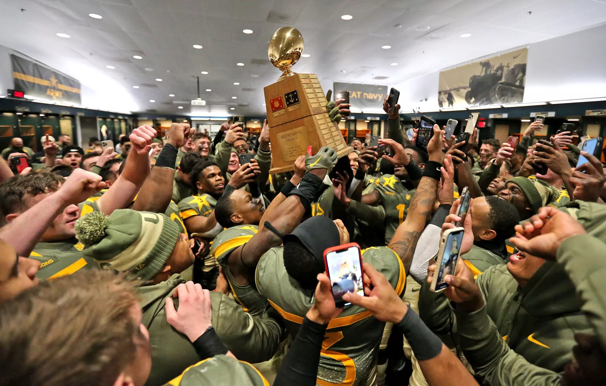 Dec 10, 2022; Philadelphia, Pennsylvania, USA; The Army Black Knights celebrate in the locker room with the Secretary’s Trophy after beating the Navy Midshipmen 20-17 in double overtime at the 123rd Army-Navy game at Lincoln Financial Field. Mandatory Credit: Danny Wild-USA Today Sports