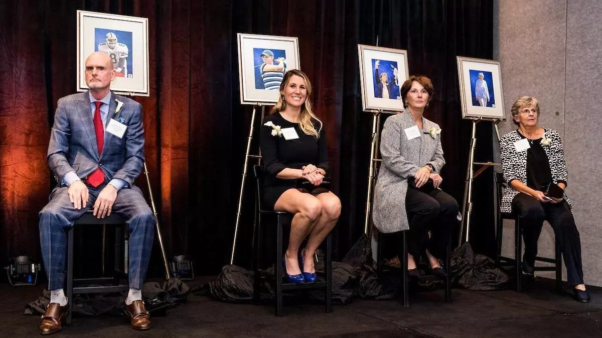 Four inductees in the 2022 Duke Athletics Hall of Fame class sit next to their portraits