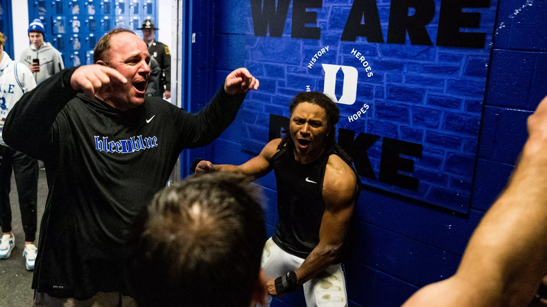 Mike Elko celebrates in the locker room after a win