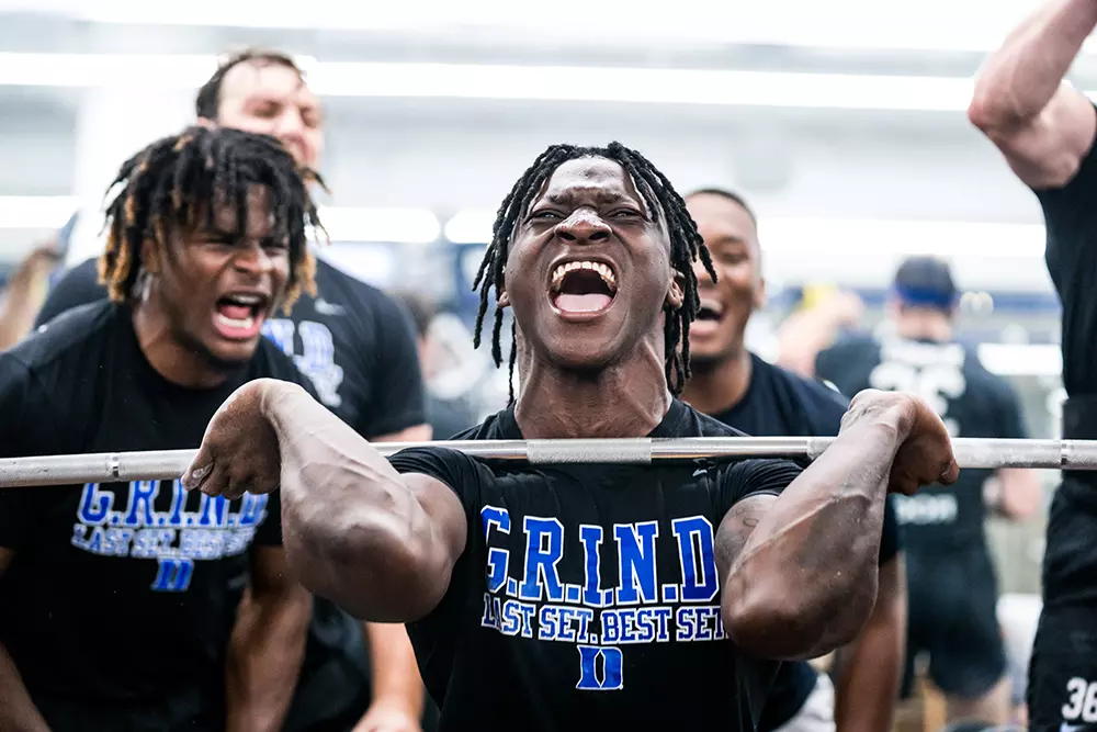 Duke football players in the weight room