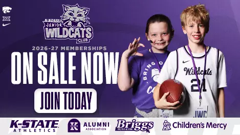 Promotional graphic for the K-State Junior Wildcats Club. Two children wearing K-State apparel and membership lanyards stand on the right side of a purple background, with one child holding a football and the other making a Wildcat hand gesture. The K-State Junior Wildcats Club logo appears above large white text that reads, “Welcome to the Club!” Smaller text below says, “Thank you for purchasing a Junior Wildcats Club membership.” K-State Athletics, Big 12, Nike, K-State Alumni Association, Briggs Auto, and Children’s Mercy logos are displayed throughout the design.