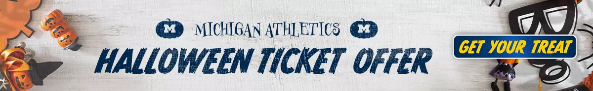 Michigan Athletics Halloween Ticket Offer with candy on table with other Halloween elements