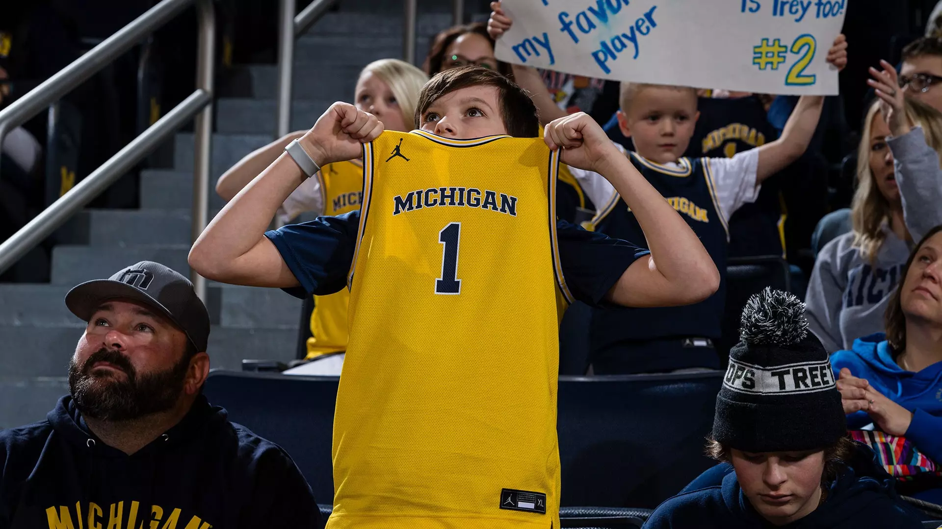 Michigan basketball fan in a maize basketball jersey