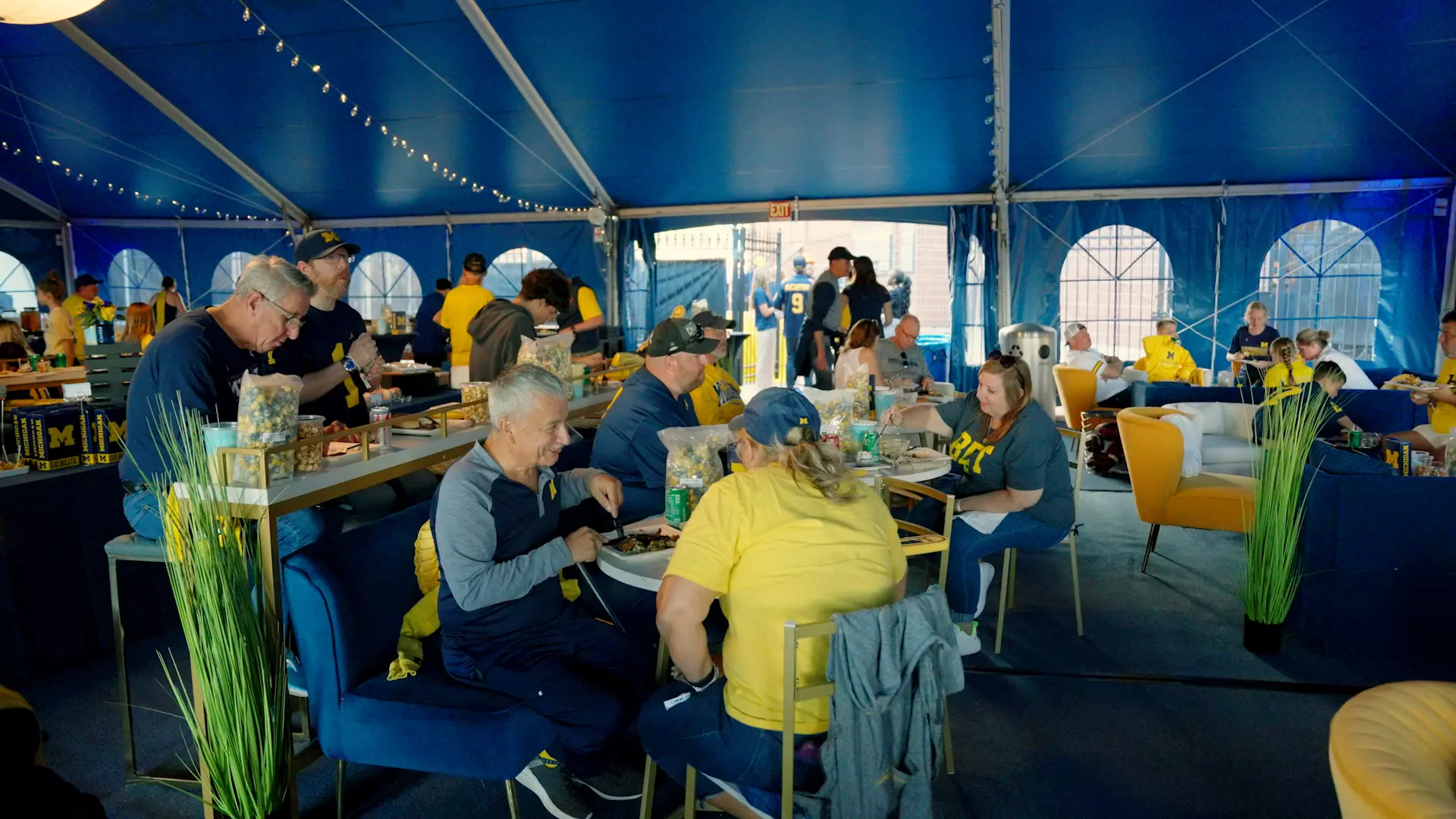 Fans sitting at tables enjoying the UMCU All-Star Lounge