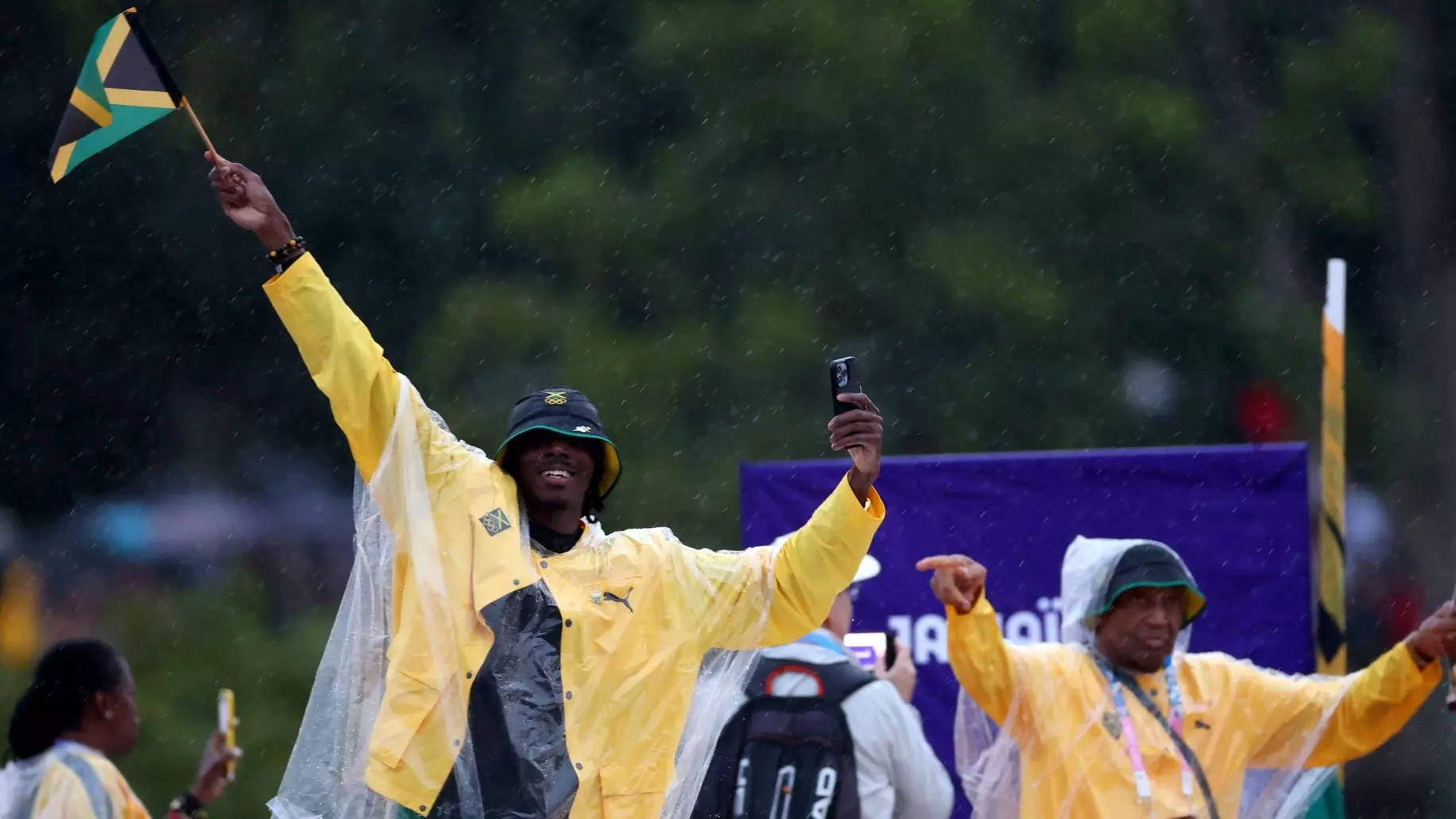 PARIS, FRANCE - JULY 26: Athletes of Team Jamaica wave handheld national flags on a boat prior to the opening ceremony of the Olympic Games Paris 2024 on July 26, 2024 in Paris, France. (Photo by Steph Chambers/Getty Images)