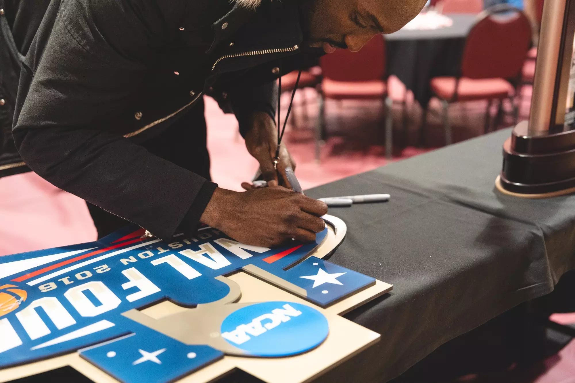 Member of the Final Four Men's Basketball Team signing Final Four sign