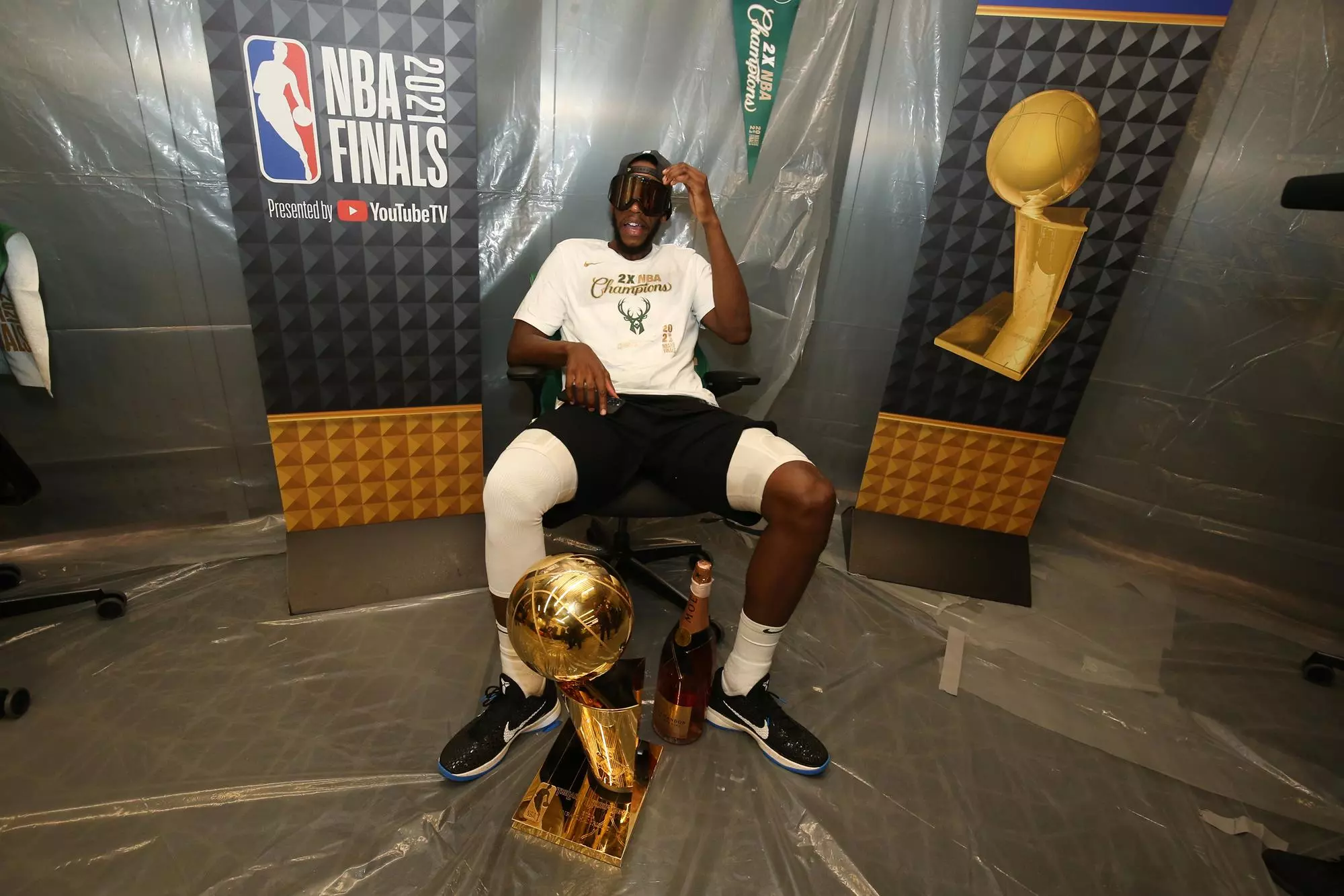 MILWAUKEE, WI - JULY 20: Khris Middleton #22 of the Milwaukee Bucks celebrates with the Larry O'Brien Trophy after winning Game Six of the 2021 NBA Finals on July 20, 2021 at the Fiserv Forum in Milwaukee, Wisconsin. NOTE TO USER: User expressly acknowledges and agrees that, by downloading and or using this Photograph, user is consenting to the terms and conditions of the Getty Images License Agreement. Mandatory Copyright Notice: Copyright 2021 NBAE (Photo by Gary Dineen/NBAE via Getty Images).