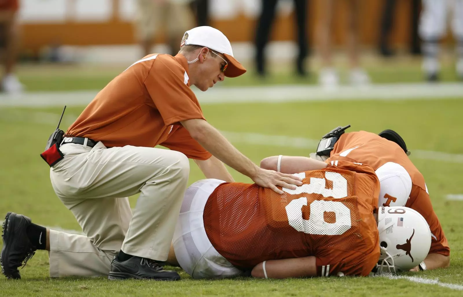 Allen Hardin helps injured football player