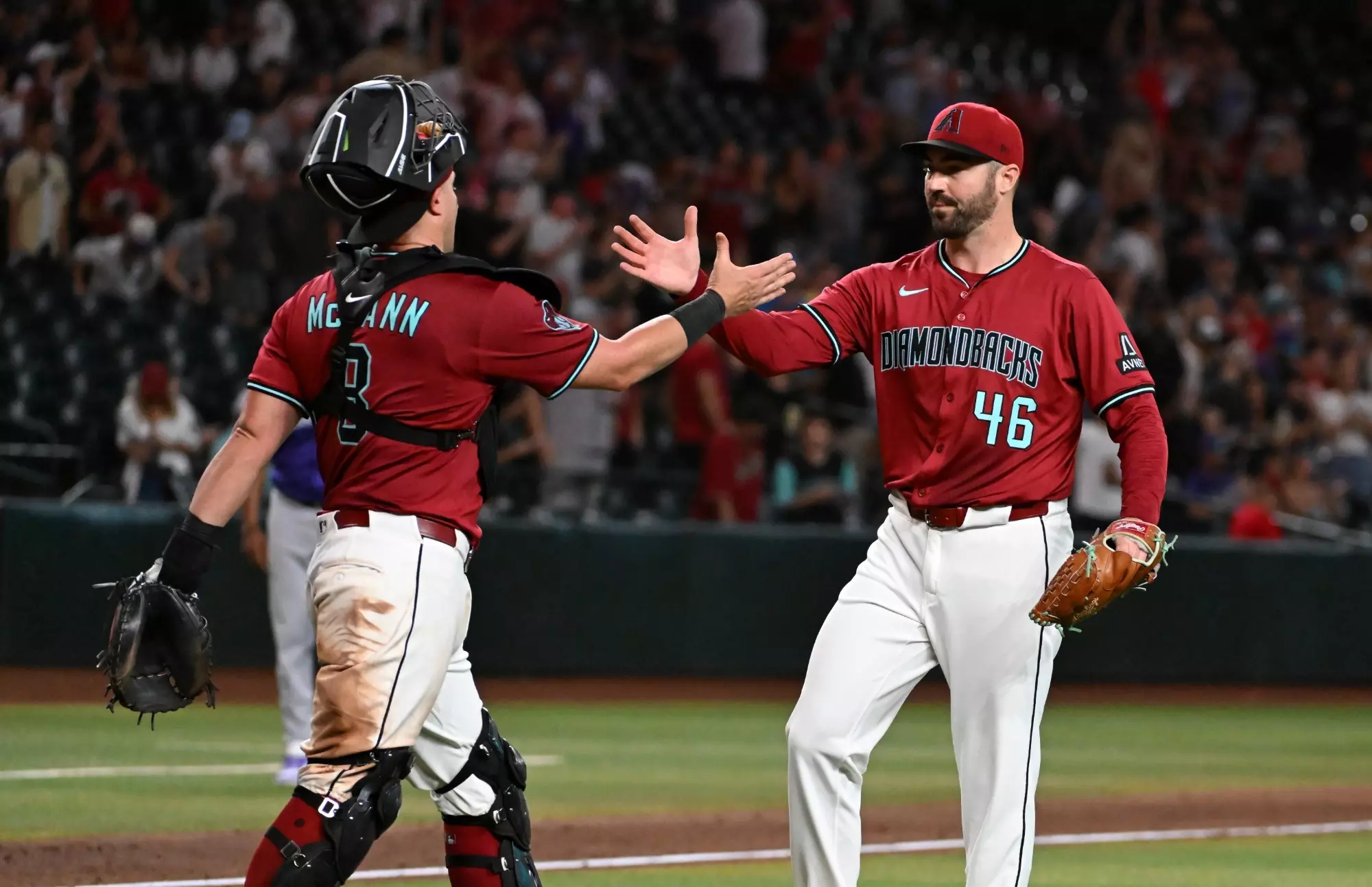 PHOENIX, ARIZONA - AUGUST 10: John Curtiss #46 and James McCann #8 of the Arizona Diamondbacks celebrate their team's 13-6 win against the Colorado Rockies at Chase Field on August 10, 2025 in Phoenix, Arizona. (Photo by Norm Hall/Getty Images)