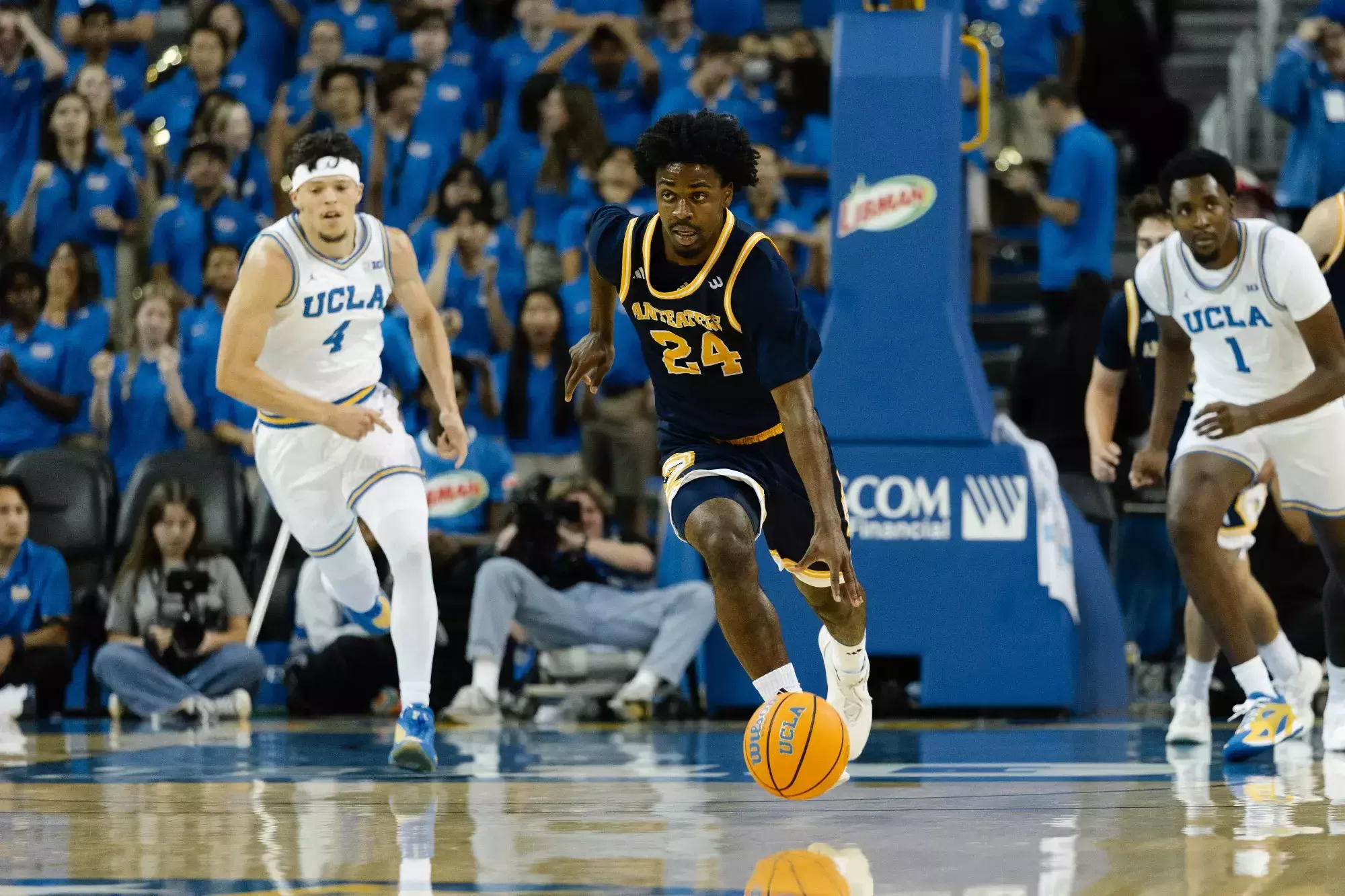 Jurian Dixon driving up the court in an exhibition game at UCLA