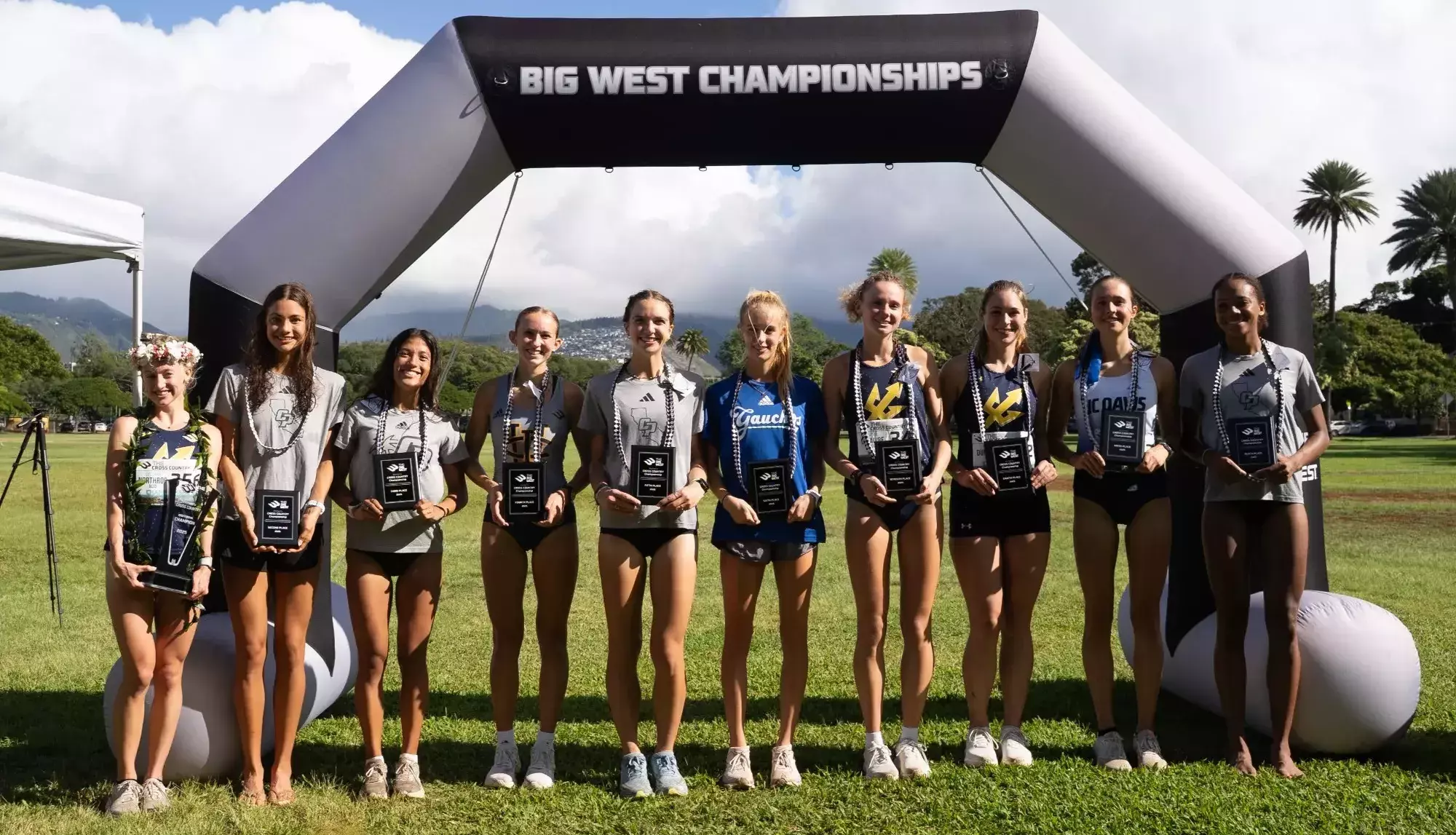 The top-10 finishers at the Big West cross country championship posing for a photo at the finish line