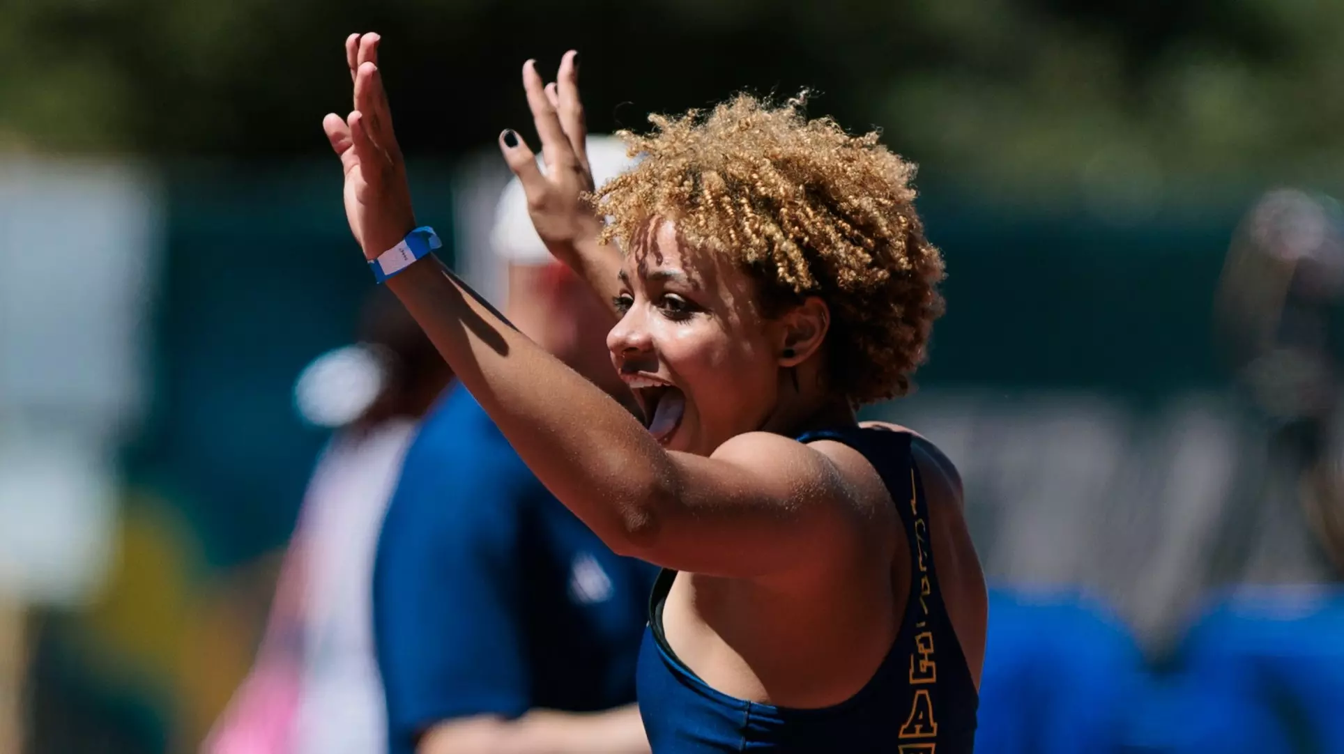 Joy Anderson with arms raised in celebration