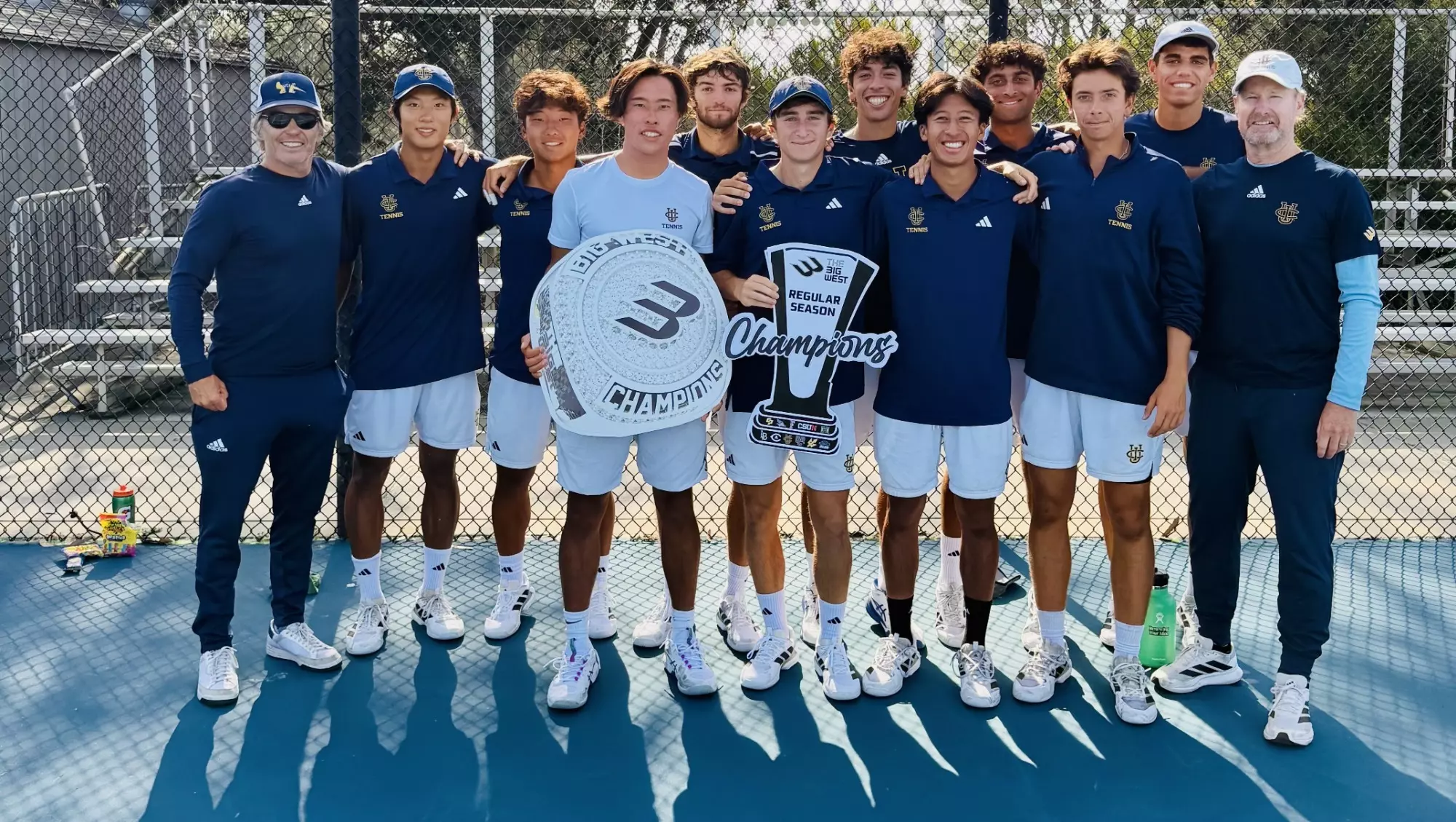 UC Irvine men's tennis team photo with Big West Championship trophy cutout