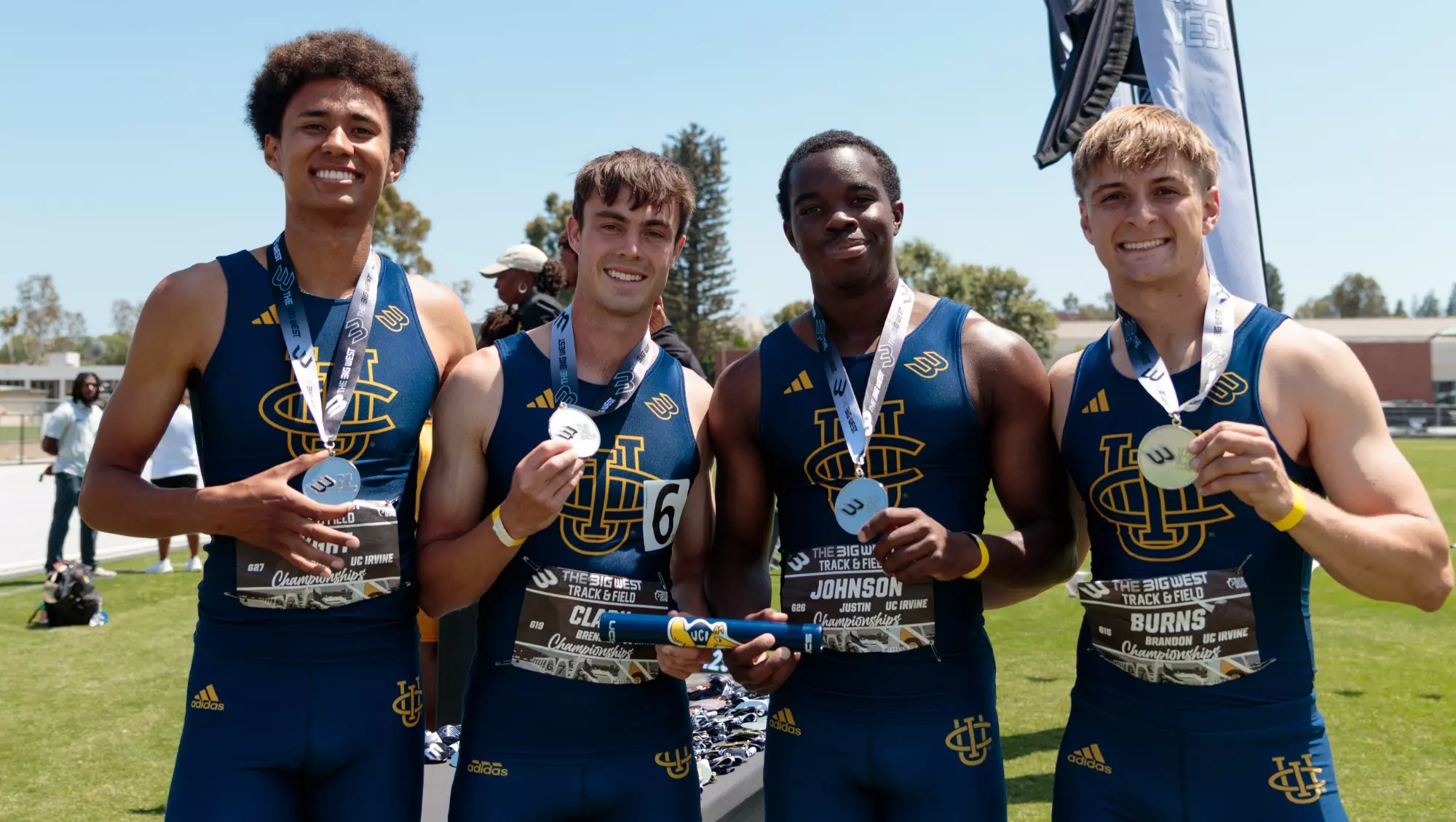 The four members of UC Irvine's men's 4x100 relay pose for a photo with their silver medals.