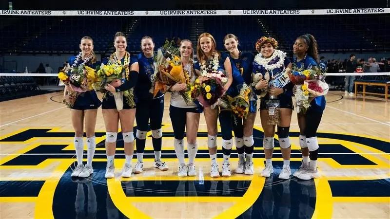 UC Irvine women's volleyball seniors pose for a photo on the court after the match