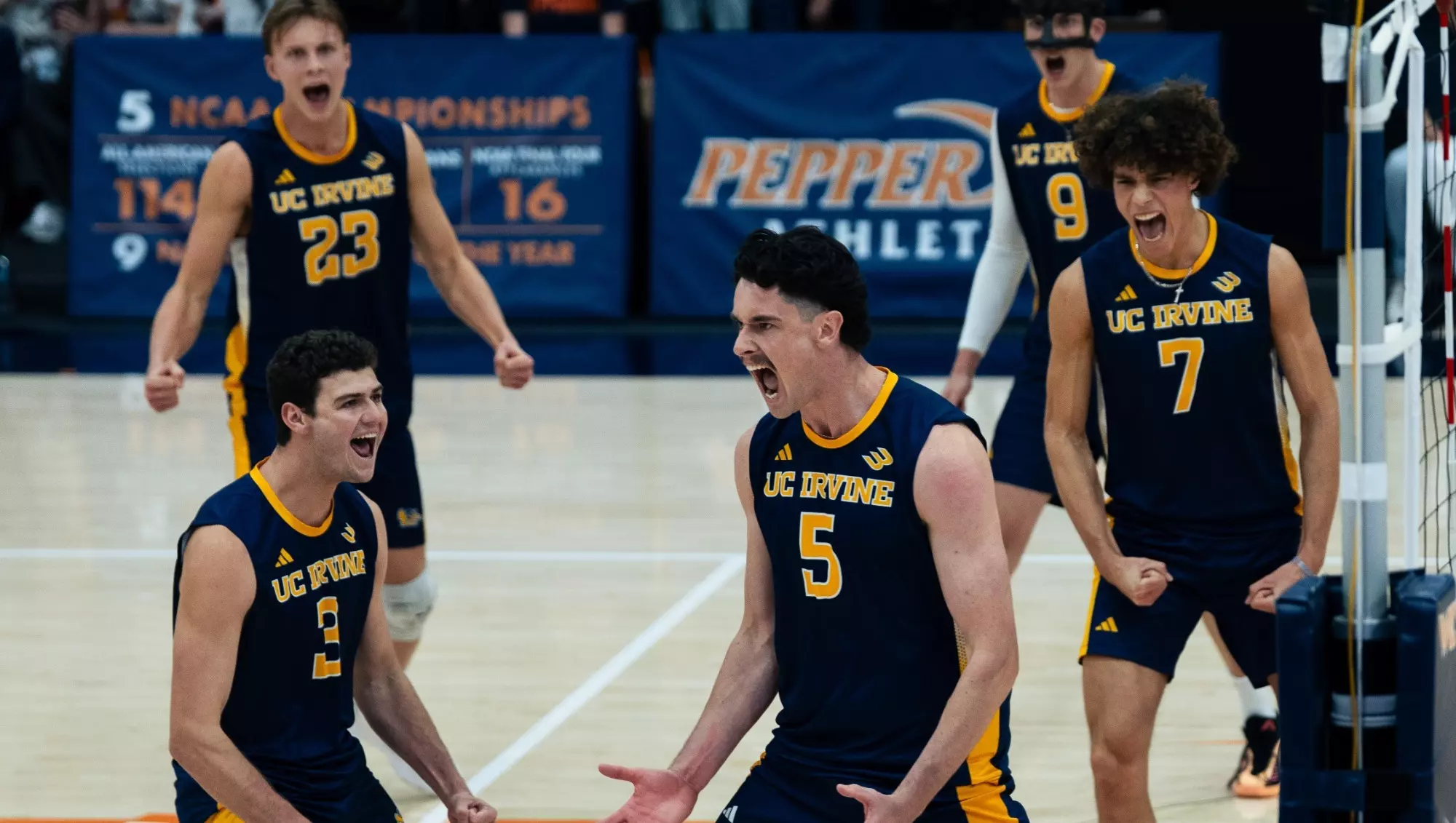 UCI men's volleyball celebrates on the court after winning a point in a non-conference match at No. 3 Pepperdine