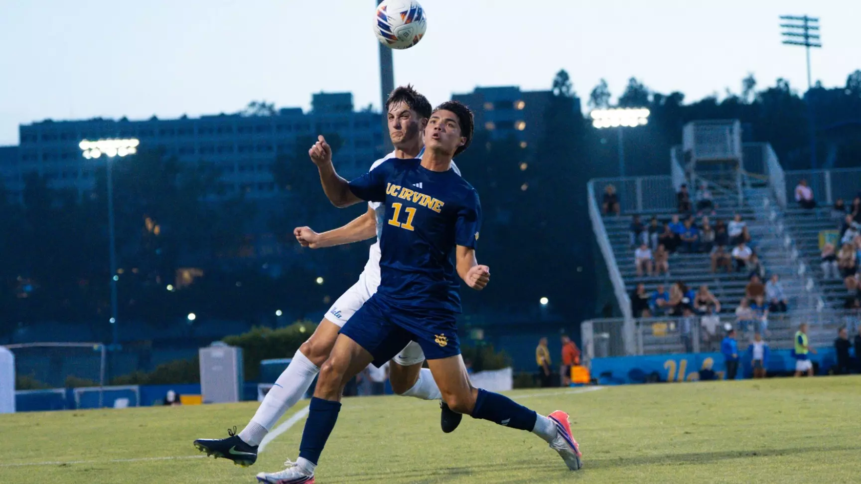 Gage Lyons fends off a Bruin in a 2026 exhibition at UCLA