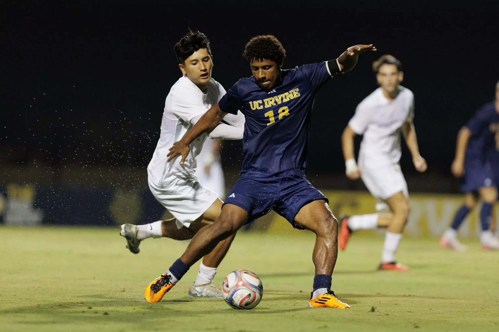 Isaac Powell dangles in front of a UNLV player in a 2026 match in Anteater Stadium