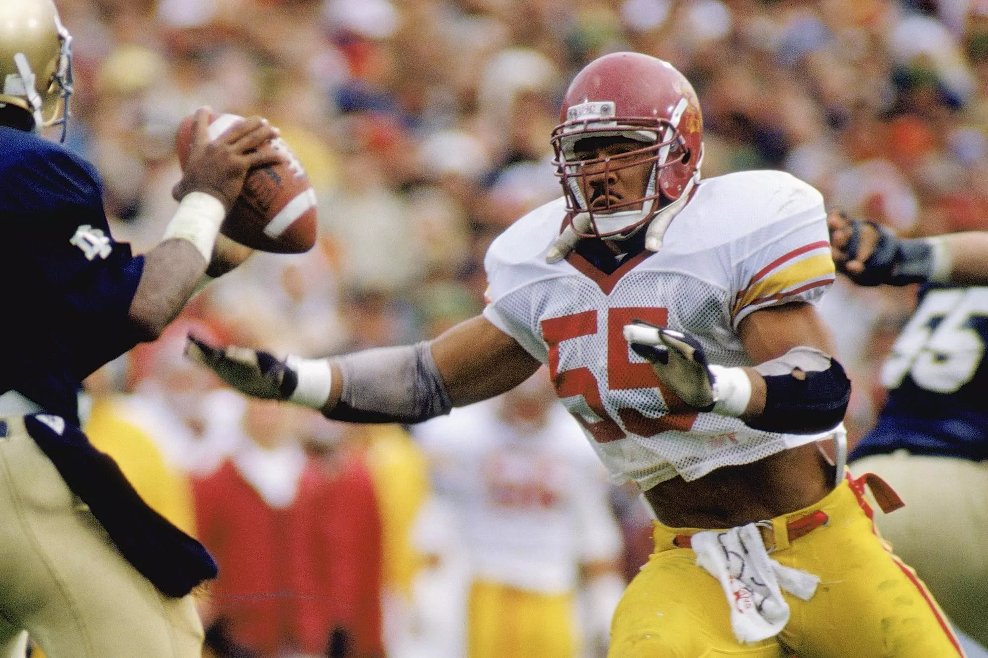 Junior Seau approaches UW QB