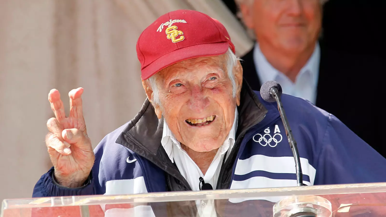 Louis Zamperini fighting on wearing USC hat