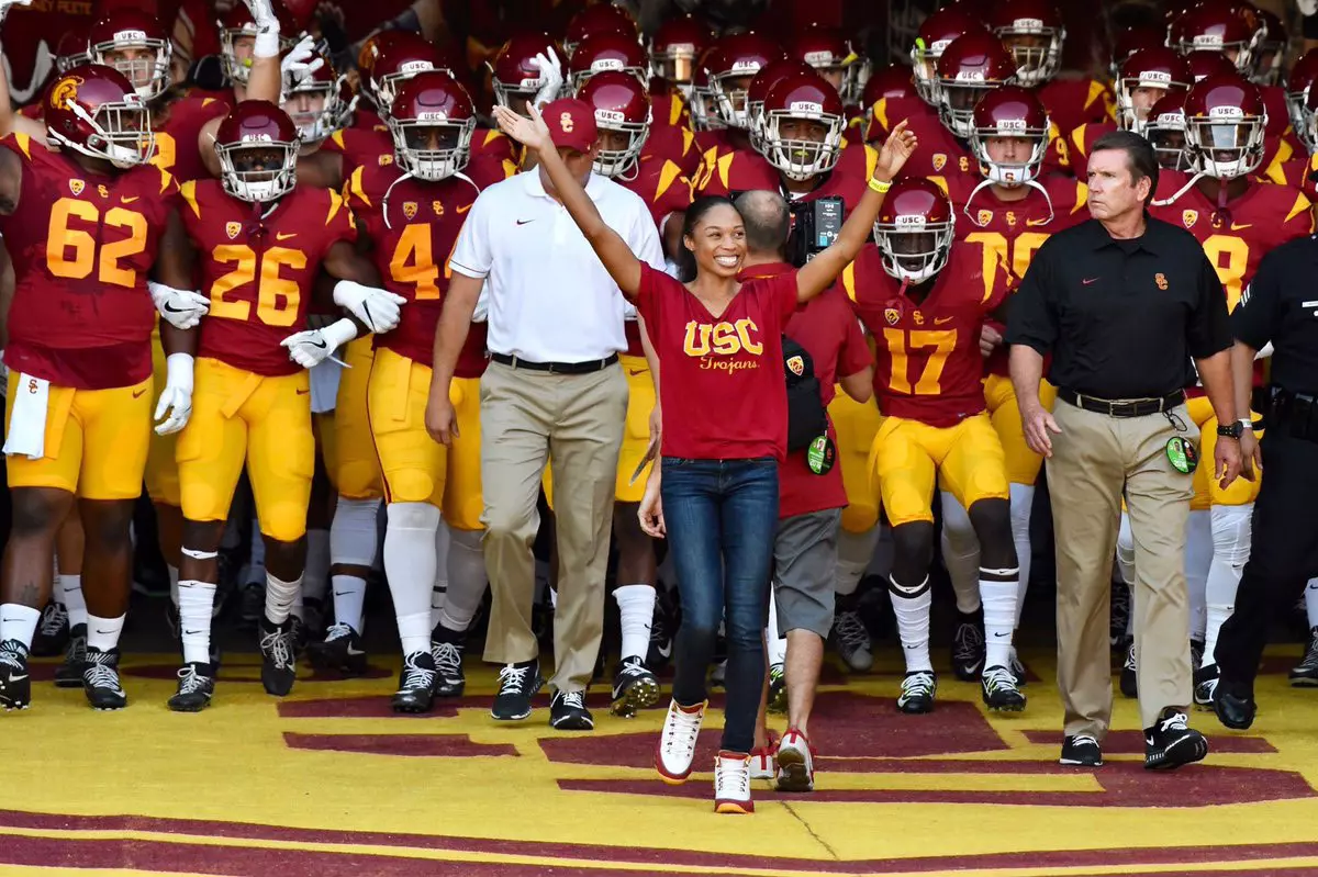 Allyson Felix leading football team out of tunnel