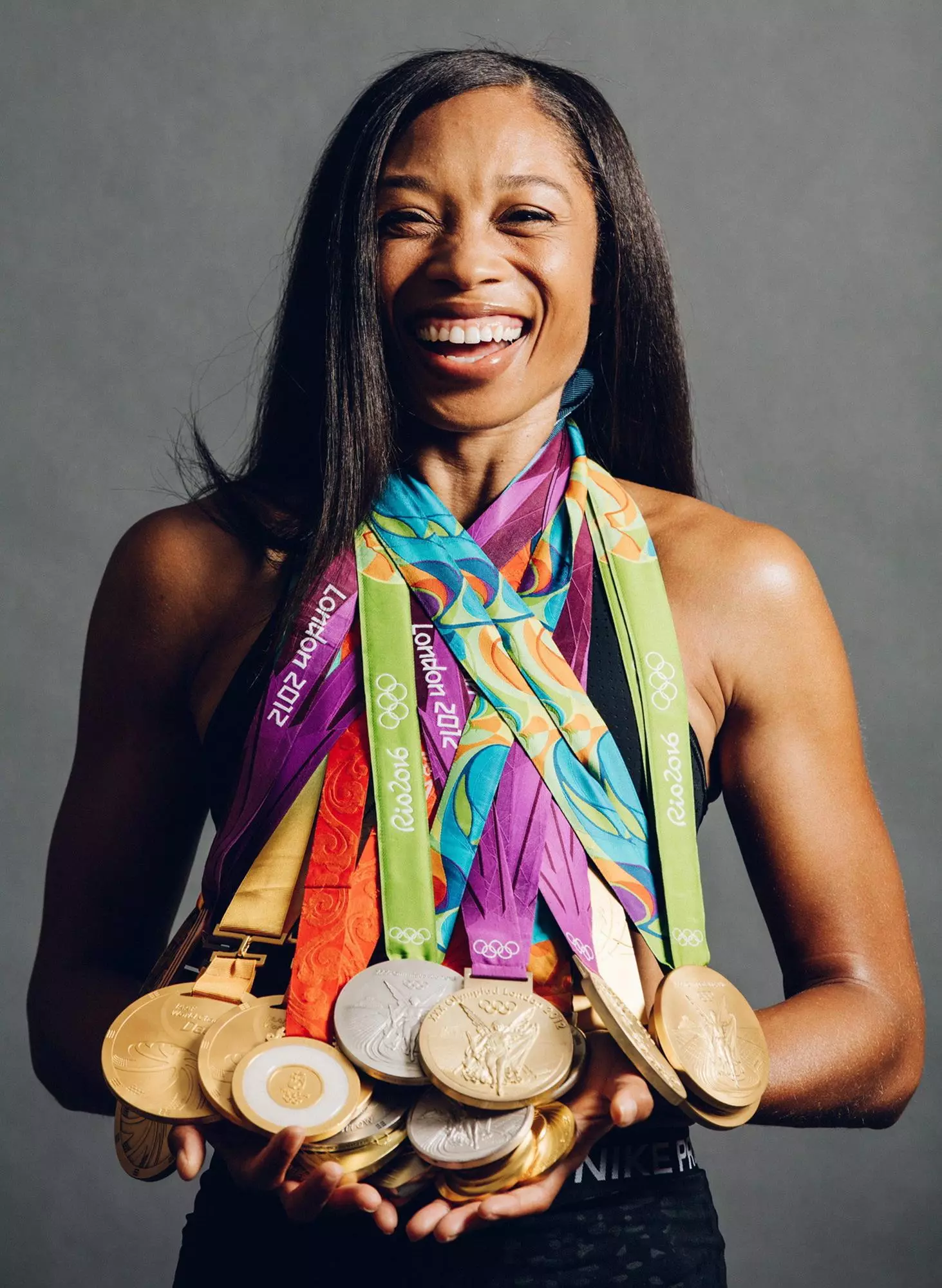 Allyson Felix holding medals