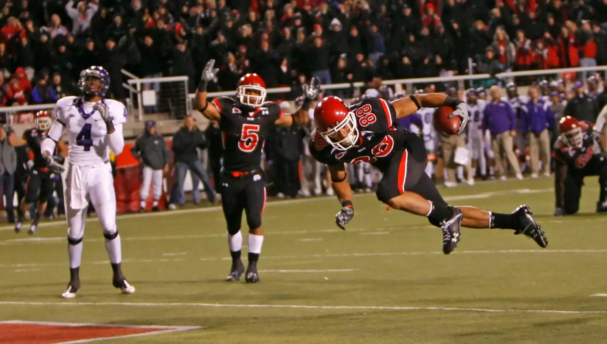 Utah's Freddie Brown scores Utah's only touchdown in the final minute as Brent Casteel signals touchdown and TCU's Steven Coleman looks on as the University of Utah defeats TCU in MWC football 13-10 in Salt Lake City, Utah Nov, 6, 2008. Photo by Tom Smart