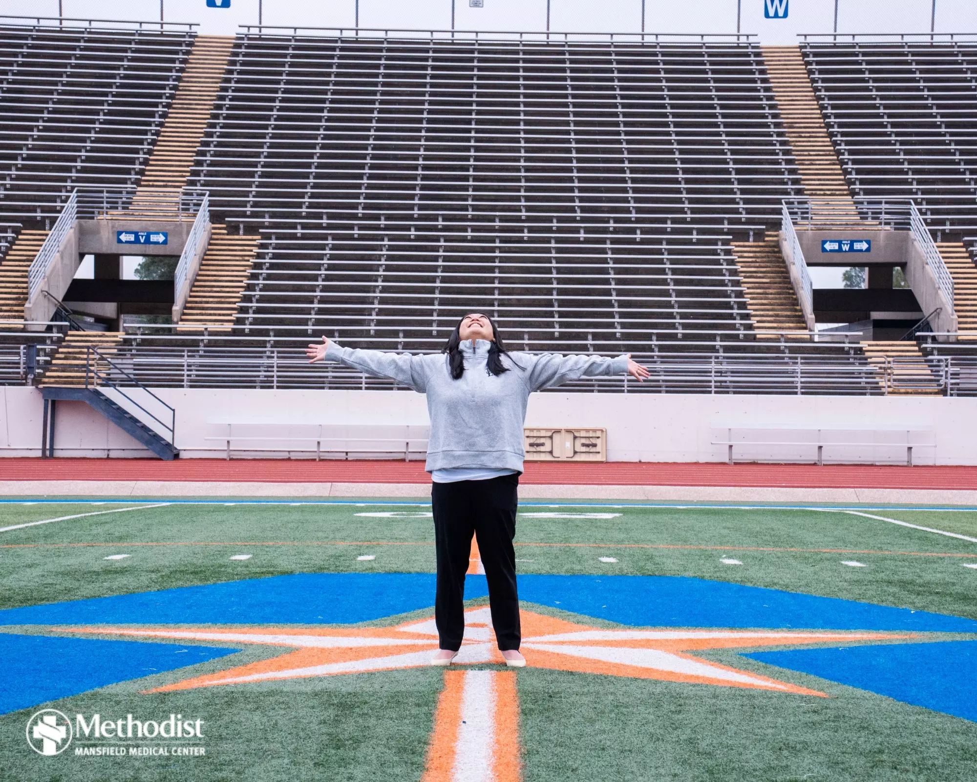 UTA Flag Football Head Coach Melinda Nguyen at midfield of Maverick Stadium in Arlington.