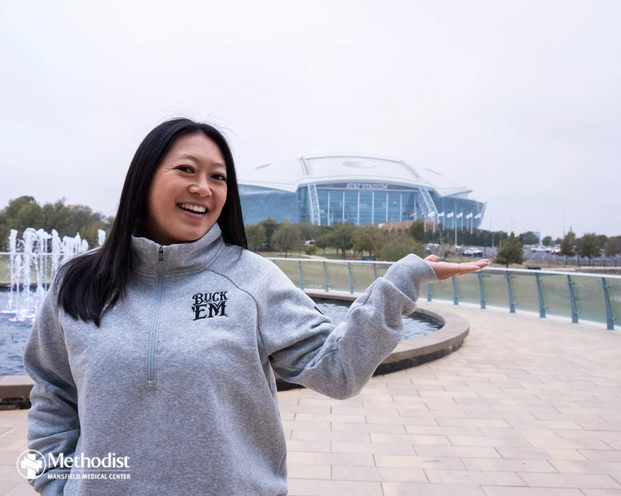 UTA Flag Football Head Coach Melinda Nguyen in front of AT&T Stadium.