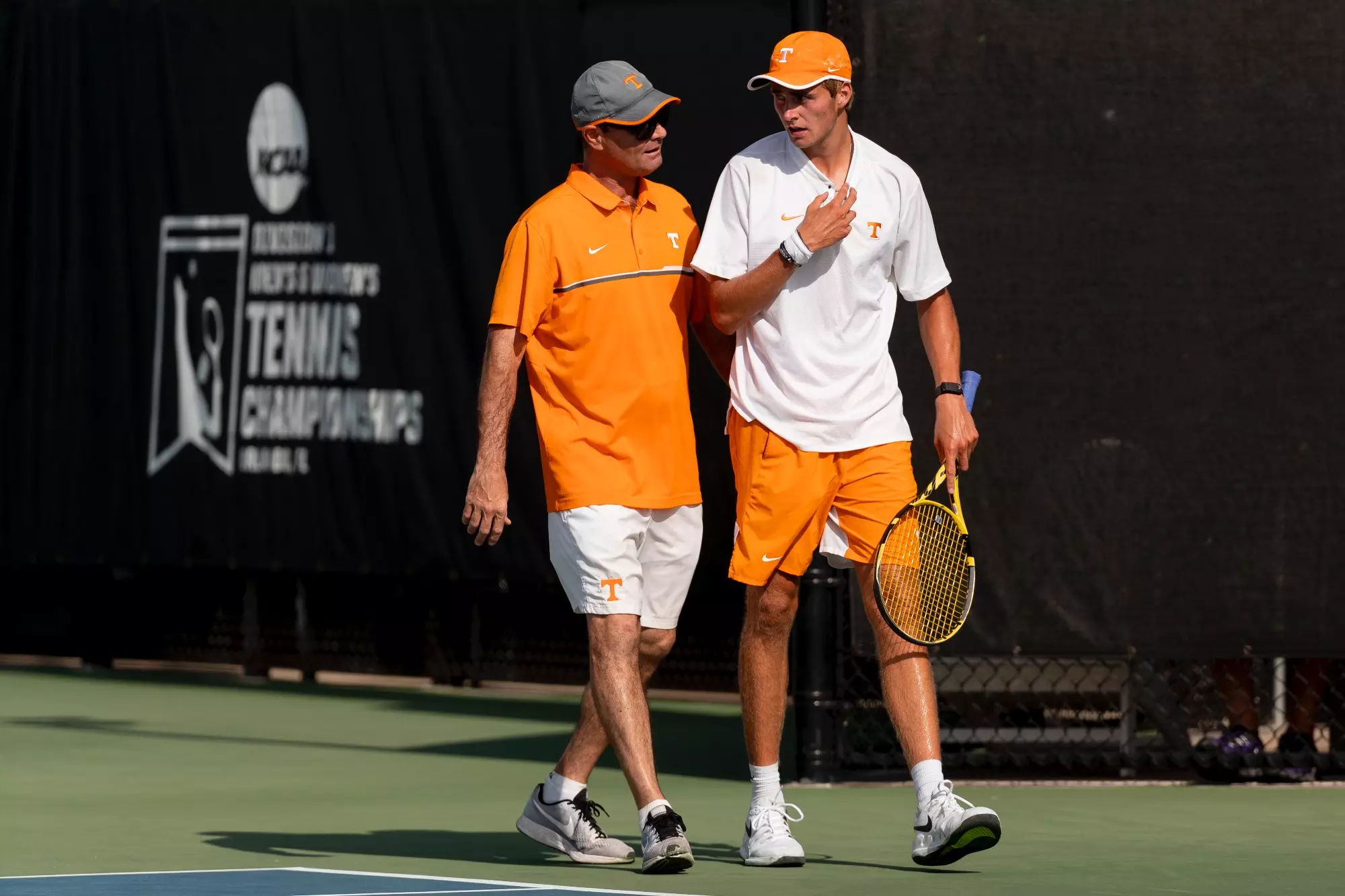 ORLANDO, FL - May 21, 2021 - Head Coach Chris Woodruff and Johannus Monday of the Tennessee Volunteers during the 2021 NCAA Men?s Tennis Tournament national semifinal match between the Baylor Bears and the Tennessee Volunteers at the USTA National Campus in Orlando, FL. Photo By Andrew Ferguson/Tennessee Athletics