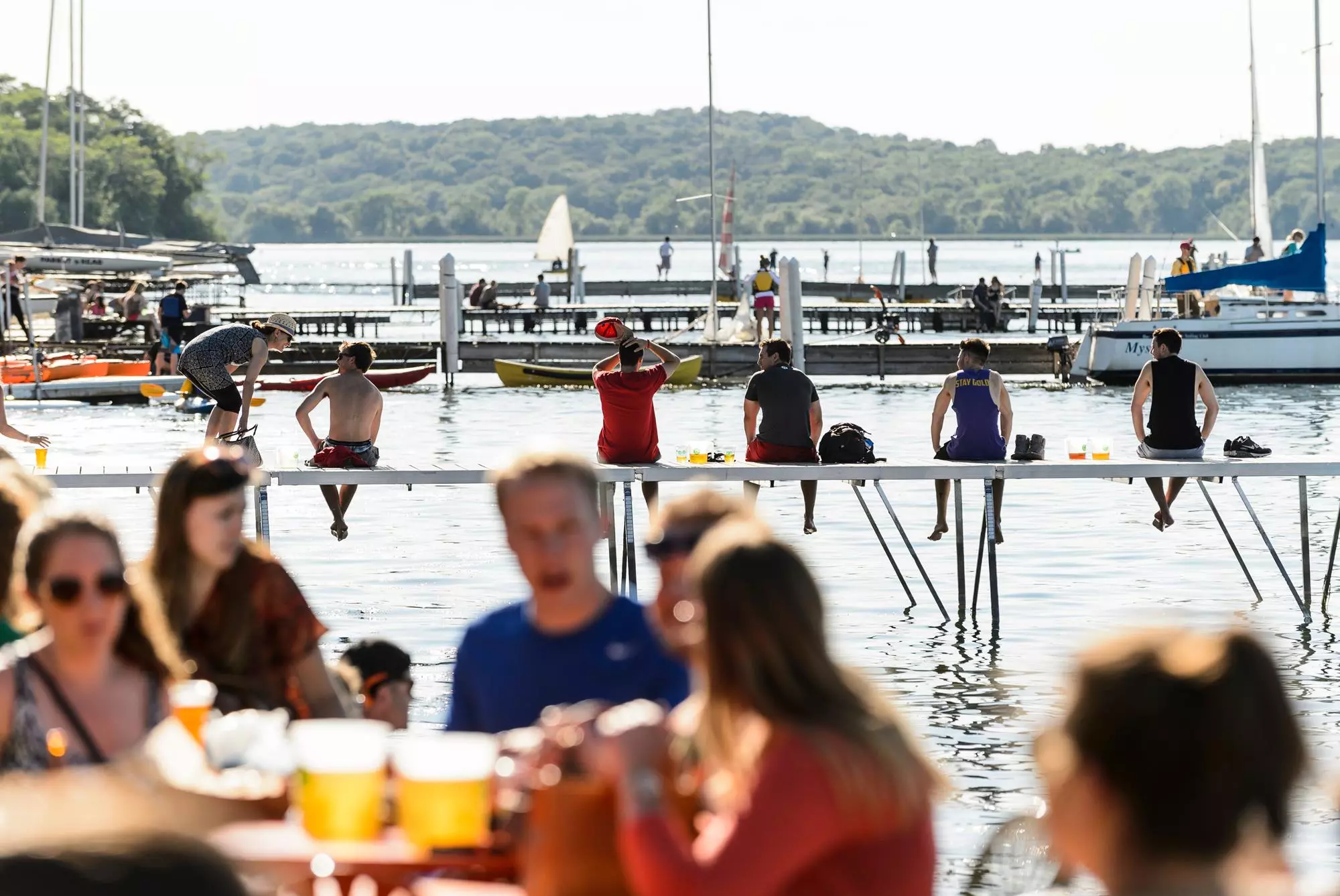 People sit on the piers at the Memorial Union Terrace at the University of Wisconsin-Madison and look out on Lake Mendota during a late spring afternoon on June 19, 2015. (Photo by Jeff Miller / UW-Madison)