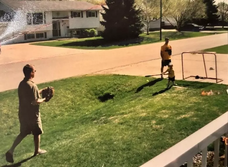 Ryan Botterill playing baseball outside with his family